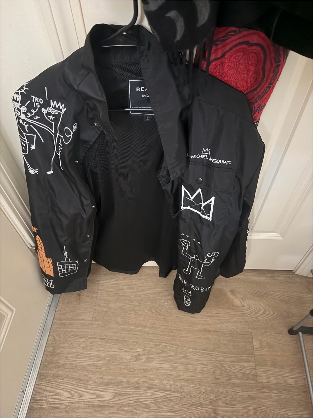 Reason Black Hooded Raincoat with White & Orange Graphic Accents